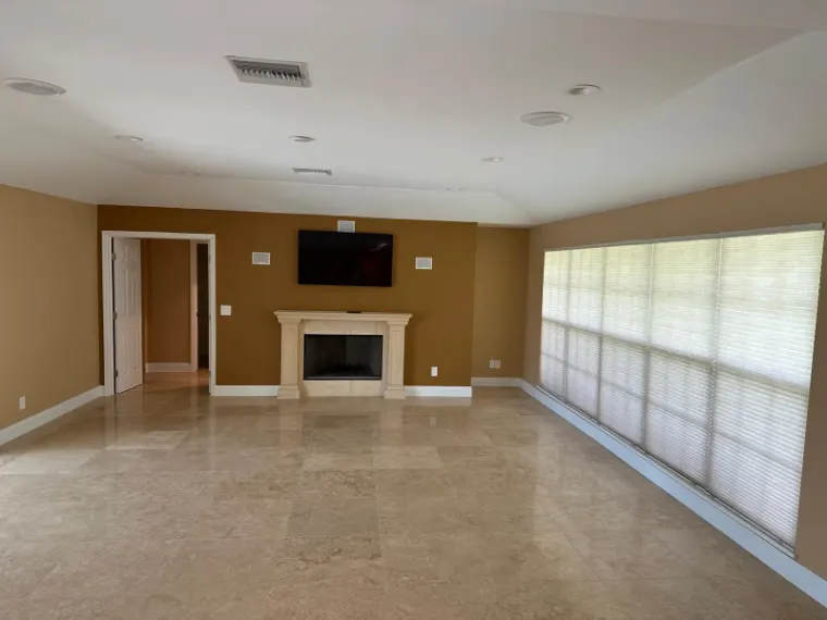 Finished living room with the fireplace and mantel on the far wall